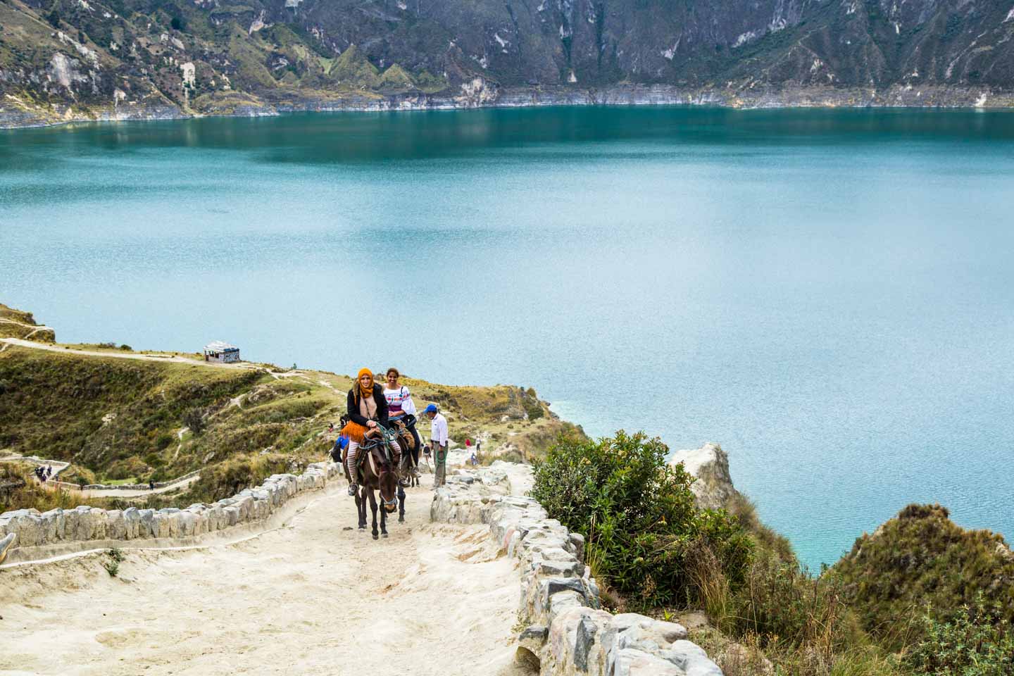 Mule-mounted hikers on their way up the Quilotoa Crater, Quilotoa, Ecuador