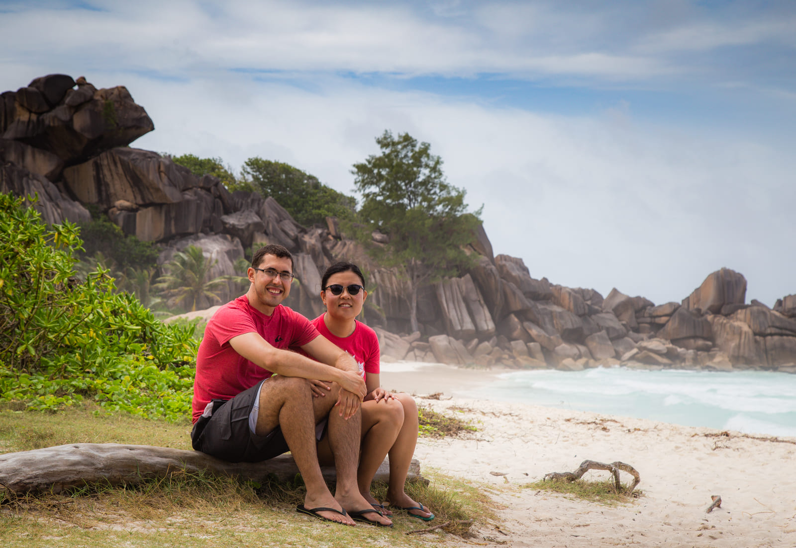 Julie & Carlos sitting on a tree branch, Grand Anse, La Digue.