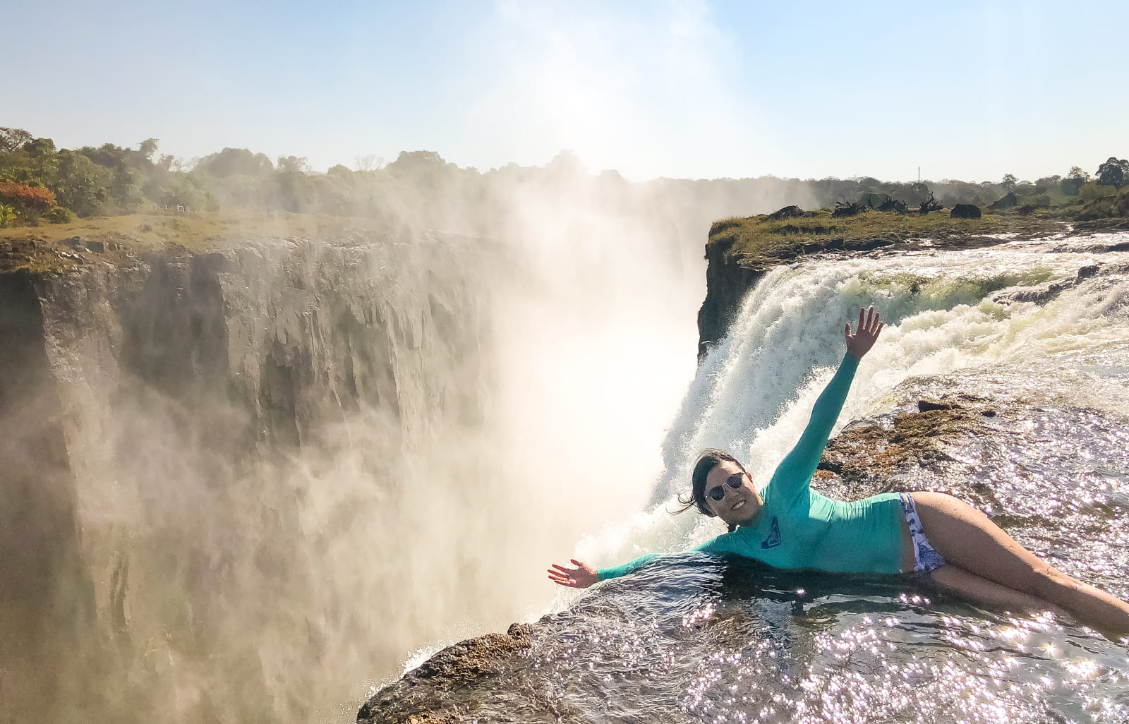 Julie lying at the top of Victoria Falls, Zambia