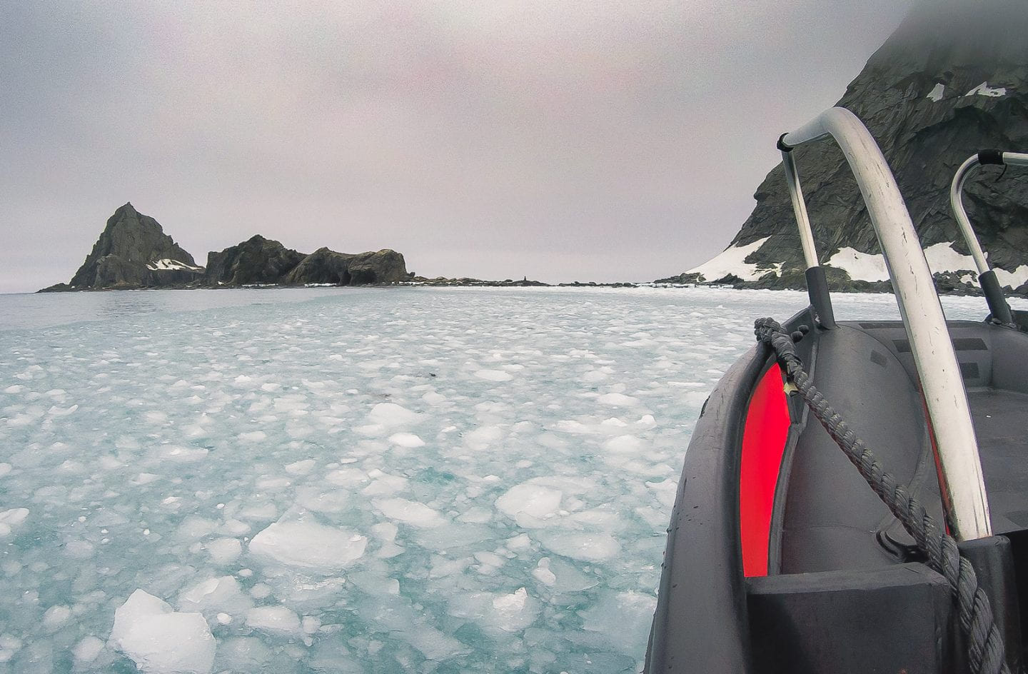 Tender boat going through ice covered water