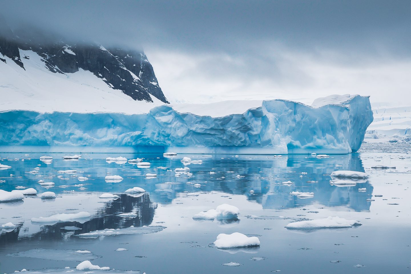 Mountain, glacier and iceberg reflected, Wilhelmina Bay, Antarctica