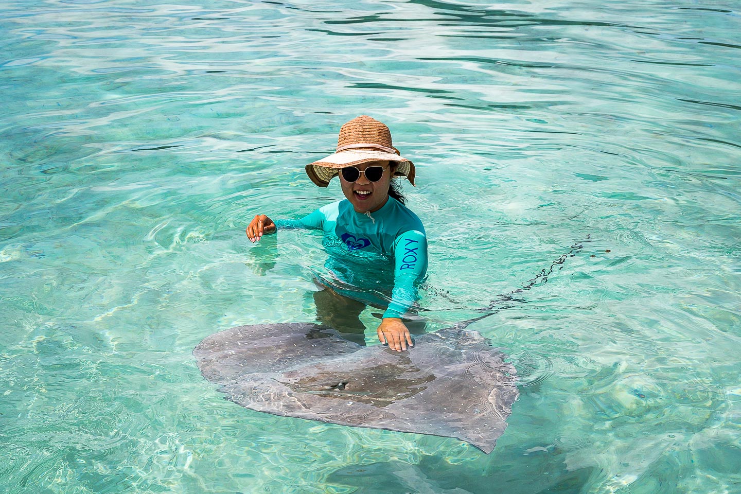Julie petting a stingray in Bora Bora, French Polynesia