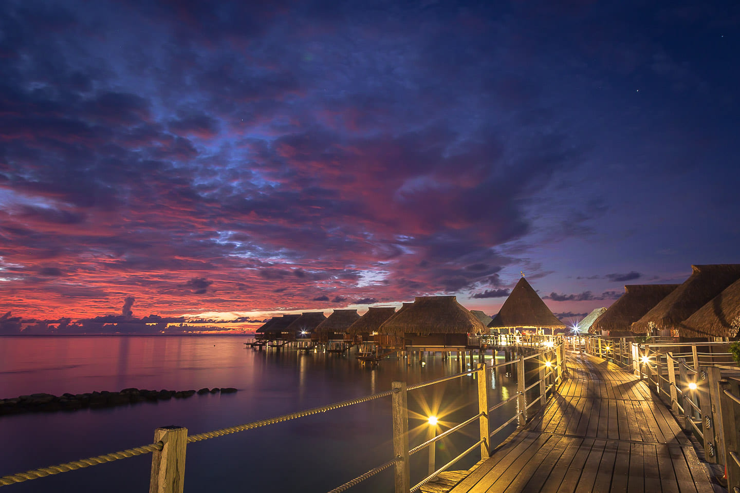 Overwater bungalows at night, Moorea, French Polynesia