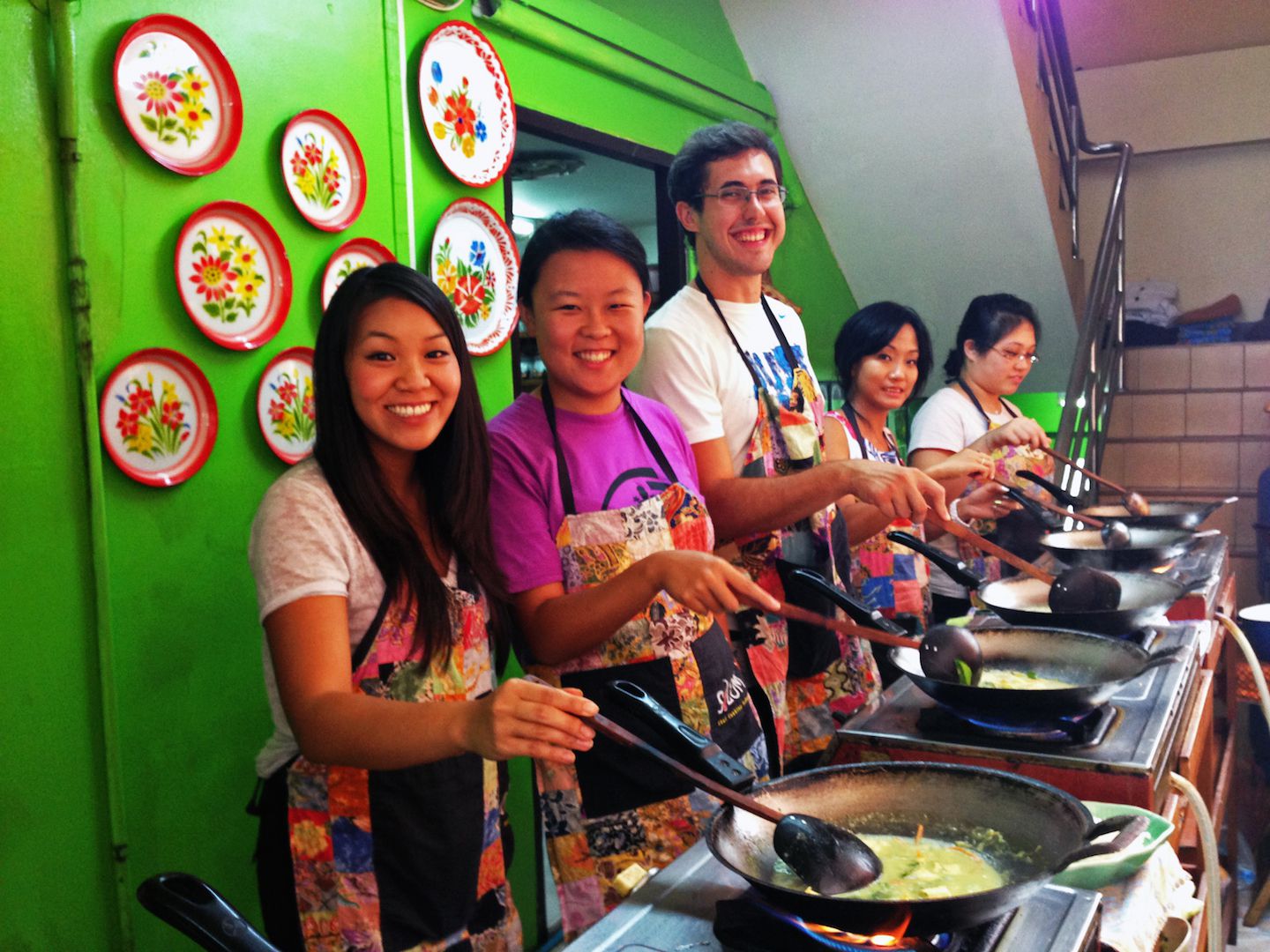 Abby, Julie and Carlos cooking green curry, Bangkok, Thailand