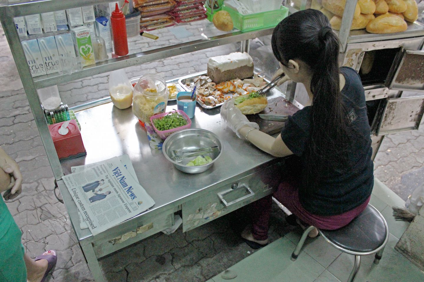 Banh my street vendor making banh my