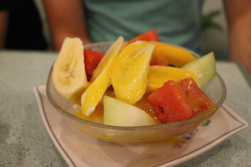 Bowl of fresh fruits, tofu, and sago drizzled in mango sauce at Chung Kee Desserts.