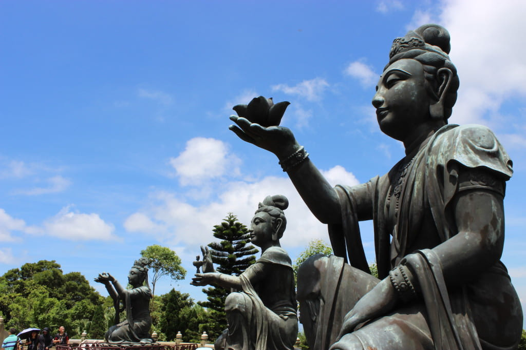 Bronze statues with offerings for Buddha.