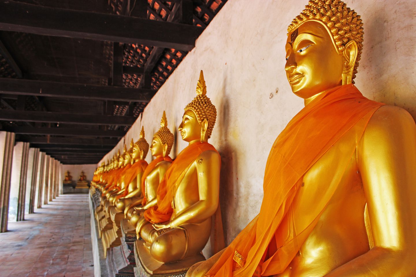 Buddha statues surrounding the main prang at Wat Phutthai Sawan, Ayutthaya