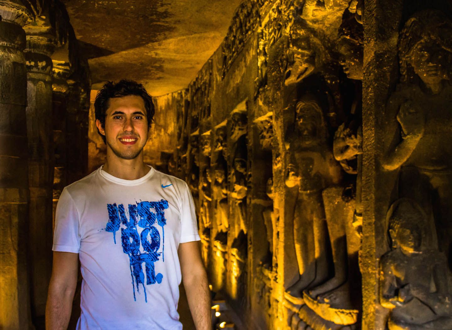 Carlos and the Buddha statues inside the Ajanta Caves, India