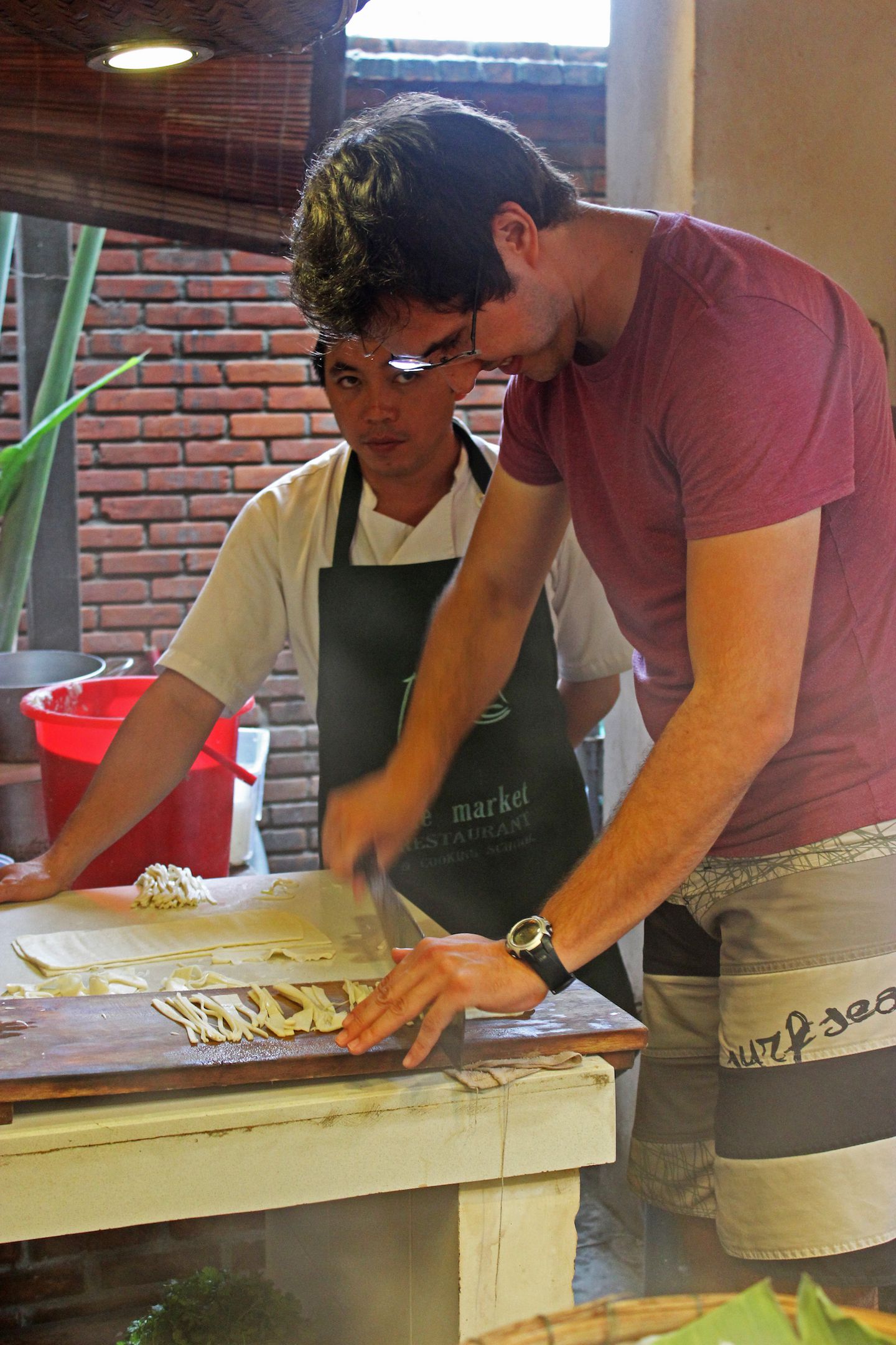Carlos attempting to hand cut noodles