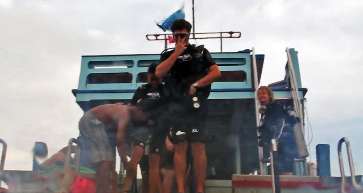 Carlos jumping into the water, White Rock Dive Site, Koh Tao, Thailand