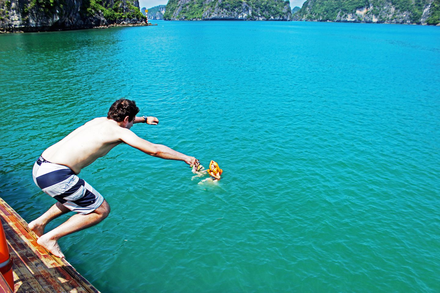Carlos jumping off the top of the boat