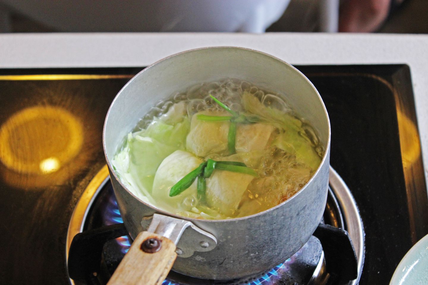 Cooking some cabbage leaf parcels shrimp mousse in broth