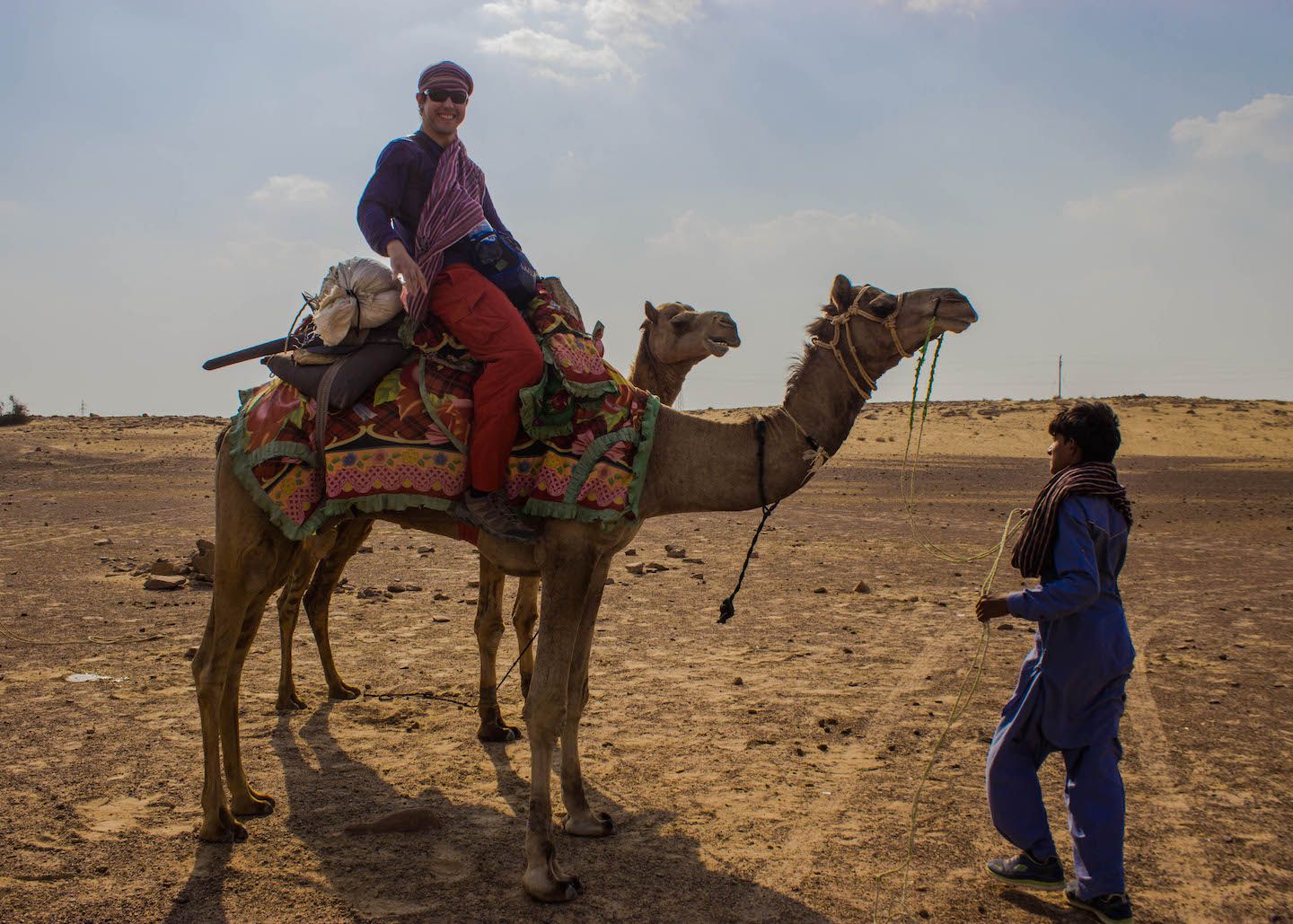 Carlos mounting a camel for the first time, Thar Desert, Jaisalmer, India