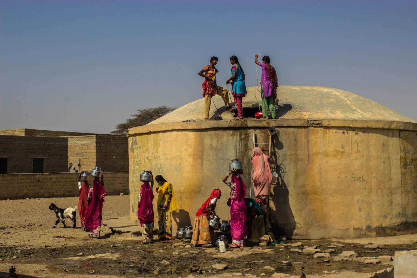 Locals getting water from the reservoir, Thar Desert, Jaisalmer, India