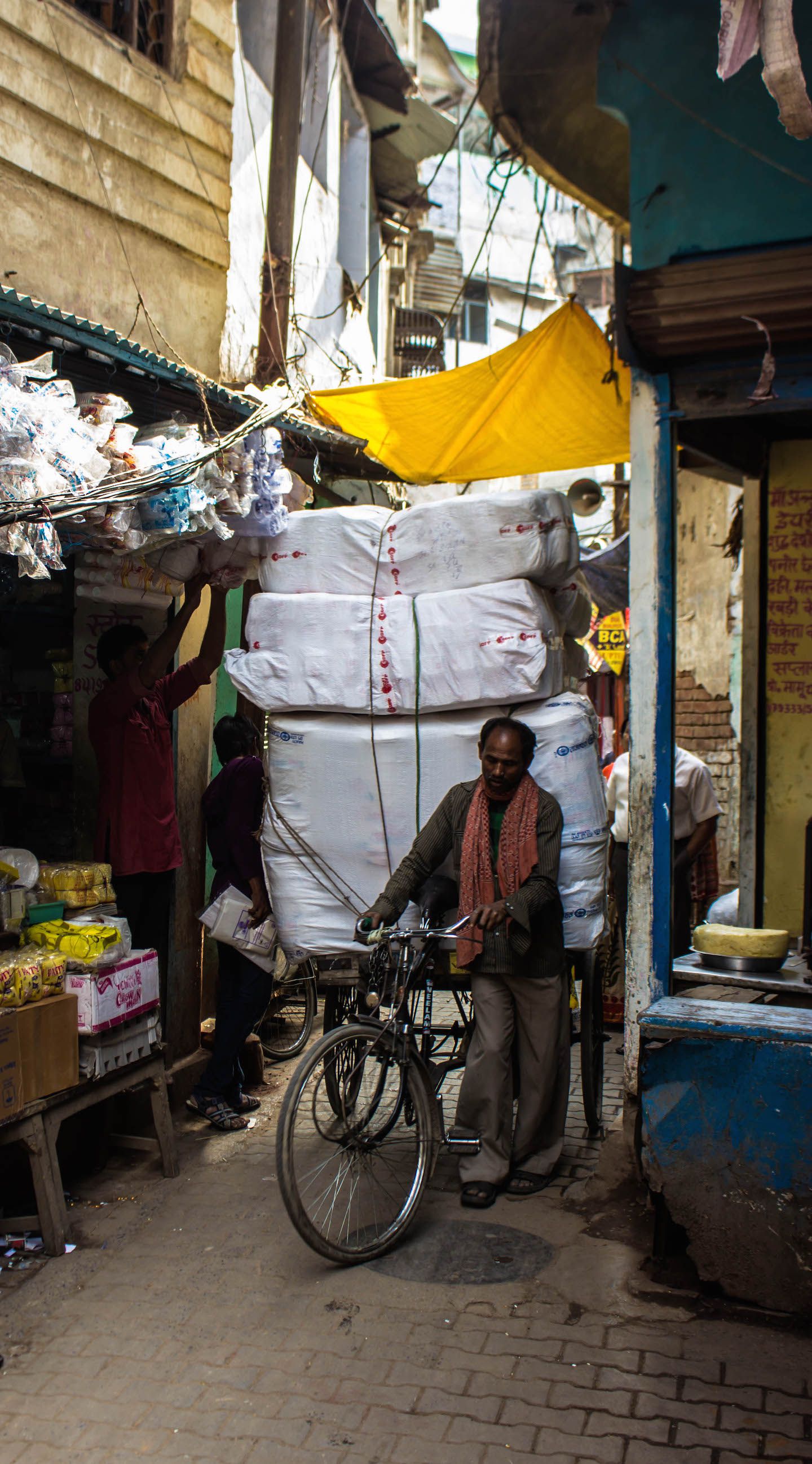 Local riding a bike at the narrow alleys, Varanasi, India