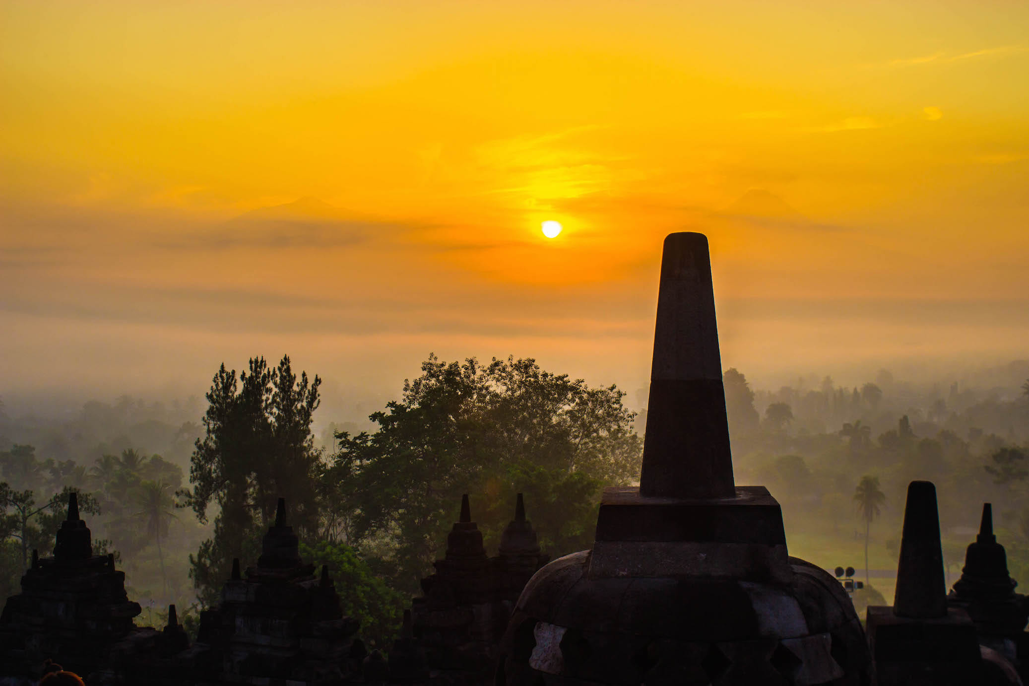 Sunrise over the misty forest around Borobudur, Indonesia