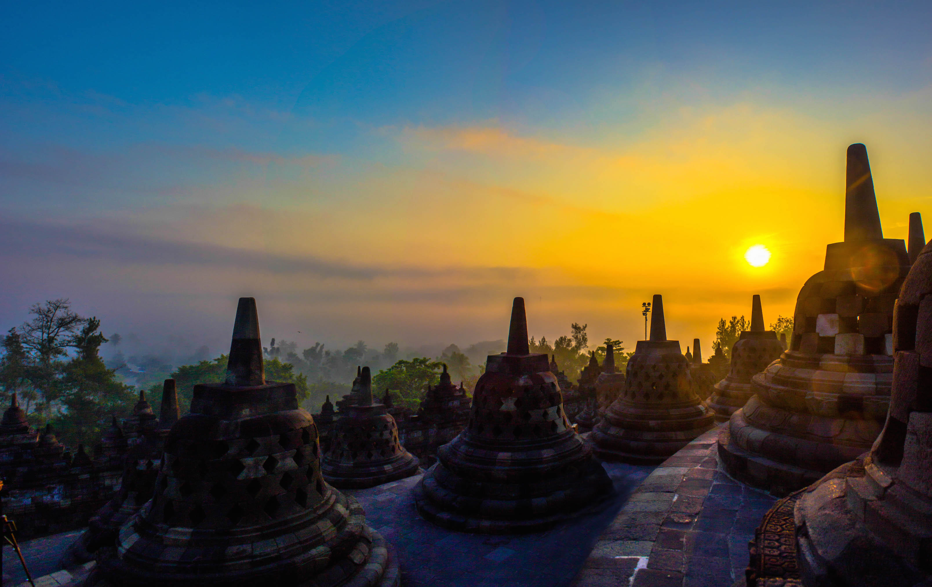 Panoramic view of the sunrise over the top levels of Borobudur, Indonesia
