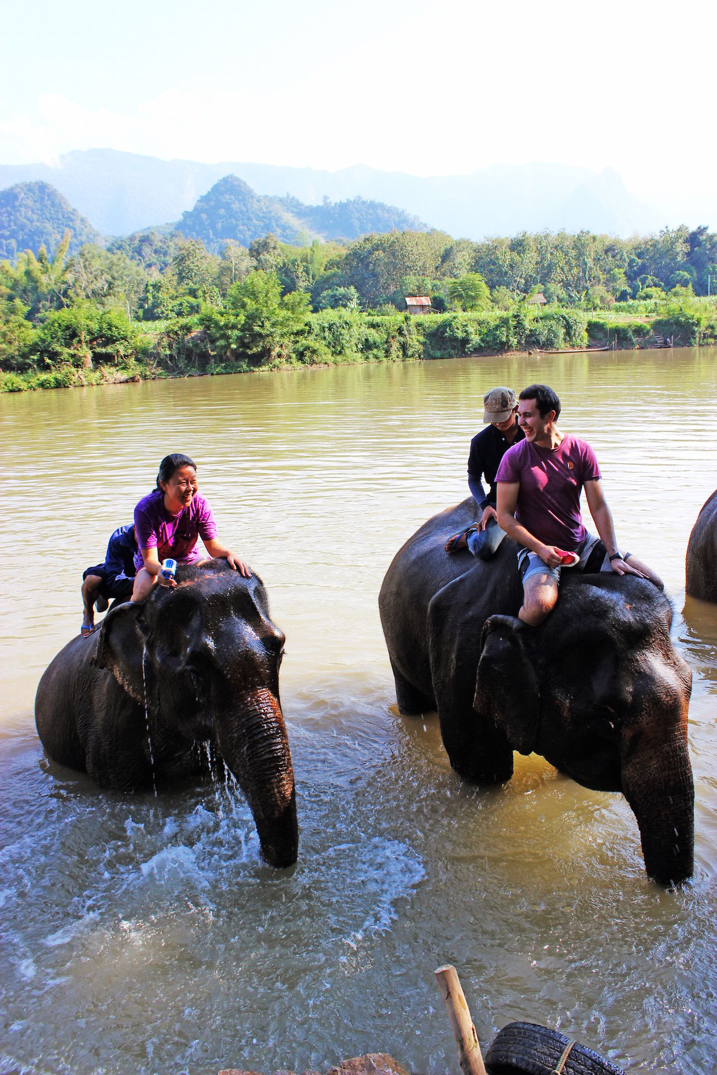 Julie and Carlos cleaning the elephants, Luang Prabang, Laos
