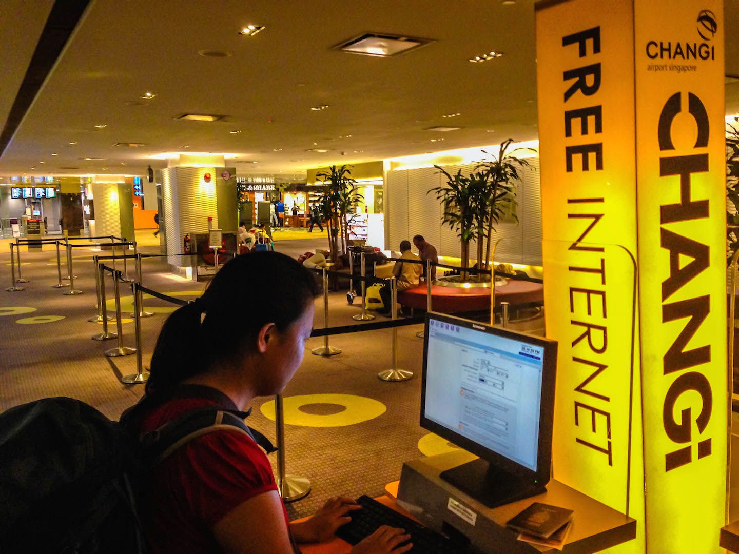 Julie booking flight tickets at Changi Airport, Singapore