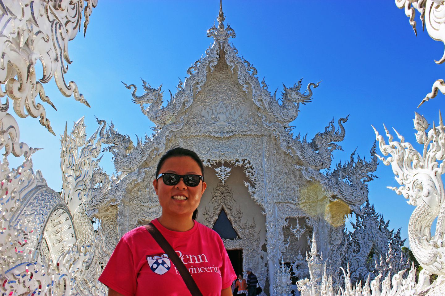 Julie crossing the bridge to the White Temple in Chiang Rai