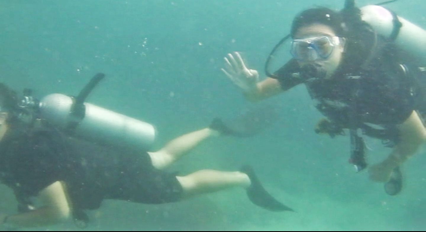 Julie waving, White Rock Dive Site, Koh Tao, Thailand