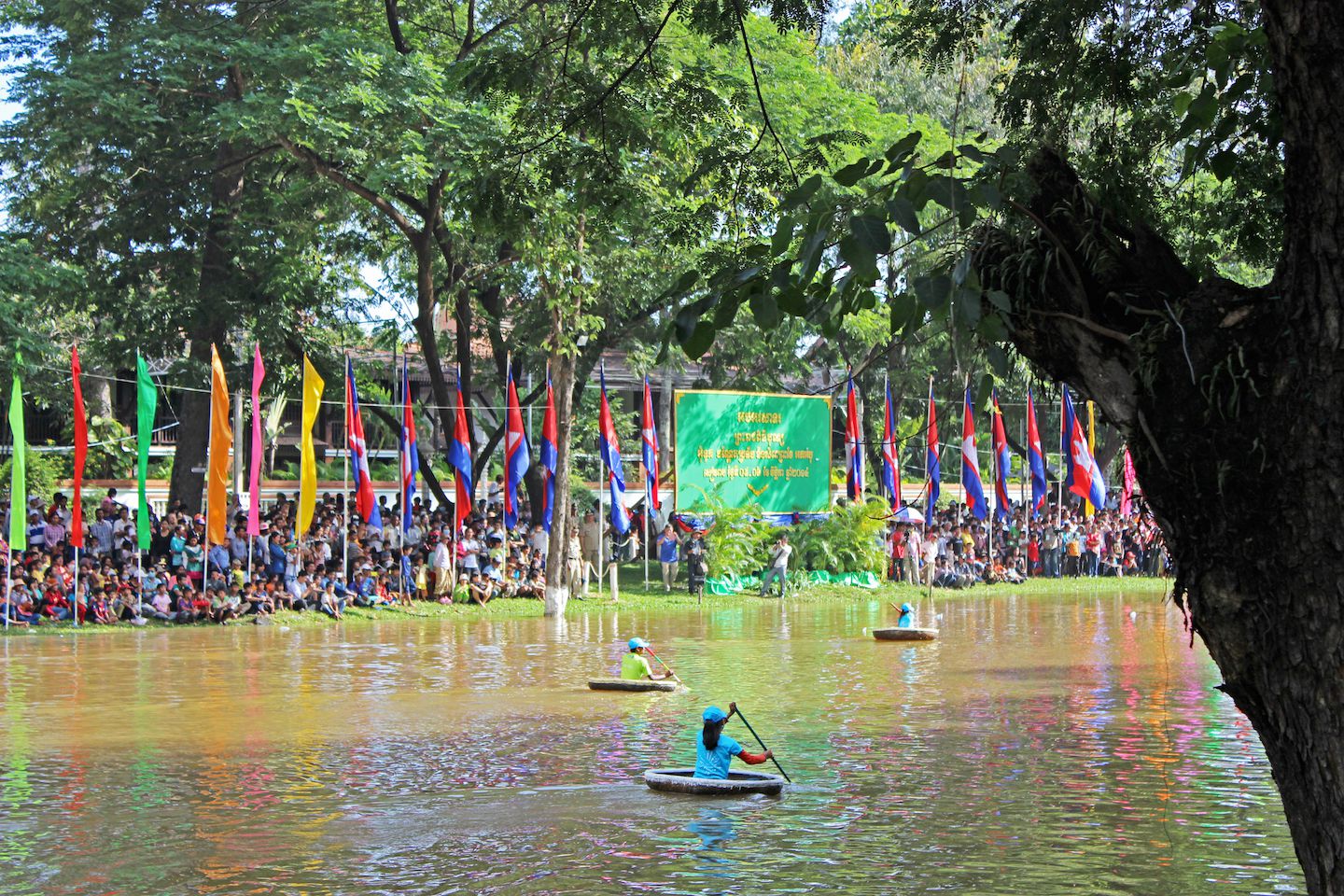 Kids rowing down on typical round boats