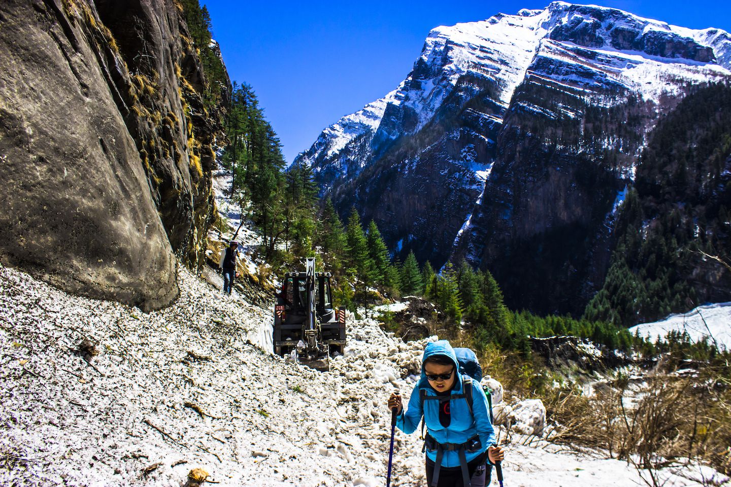 Julie trekking with the machines clearing an avalanche site on the trail, Annapurna Circuit, Nepal