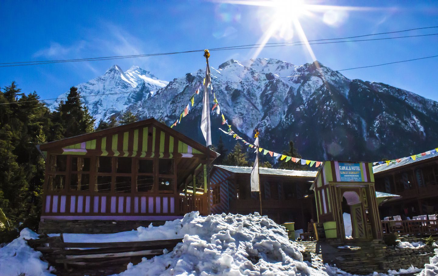View of the lodges in Dhikur Pokhari with Annapurna II in the background, Nepal