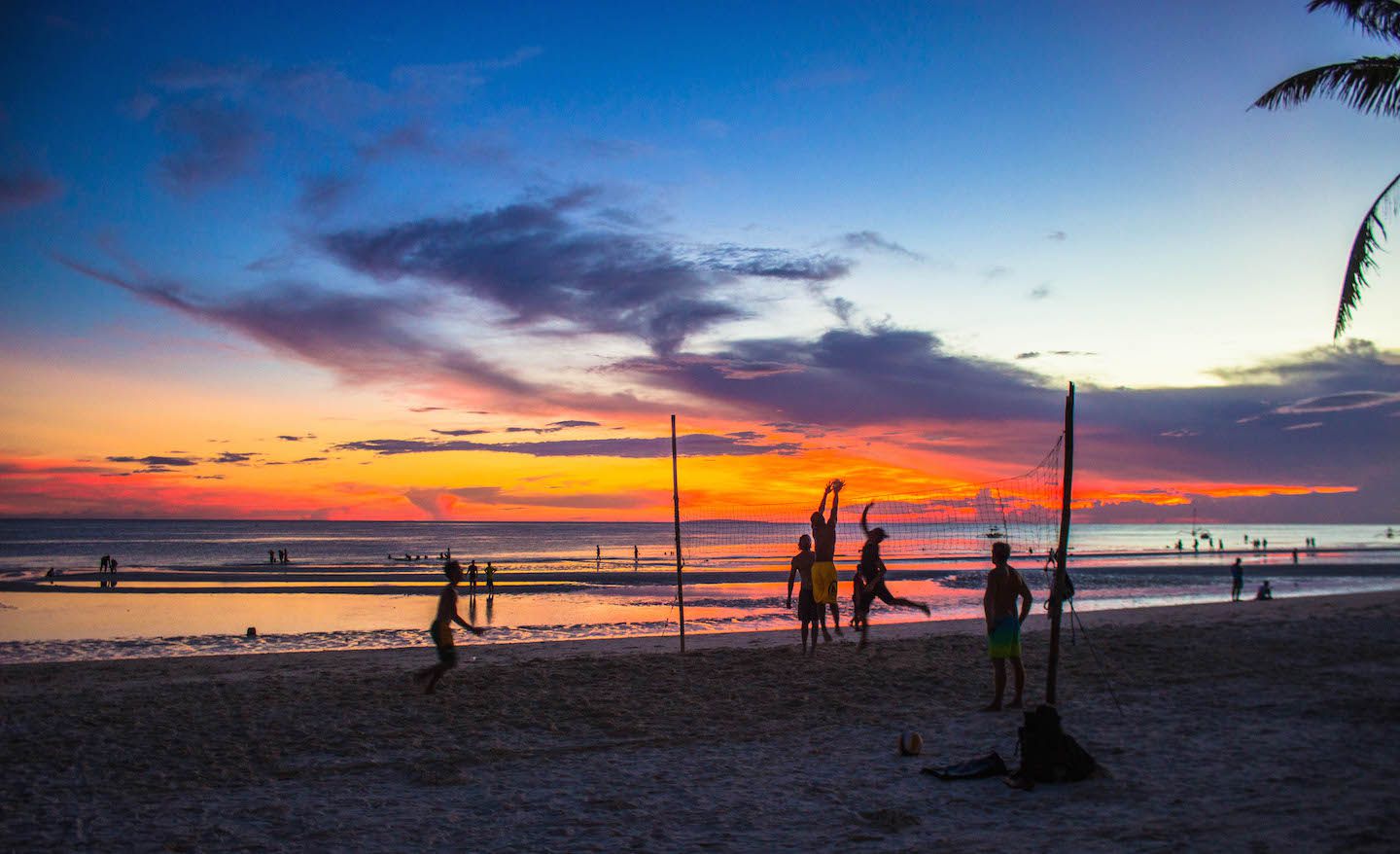 Playing volleyball at sunset, Boracay, Philippines