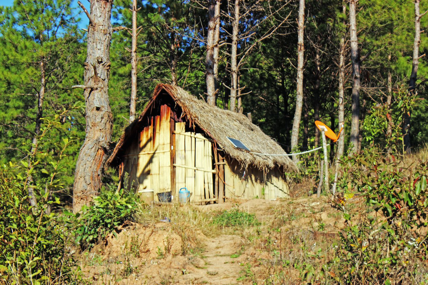 Straw hut with solar panel and antenna, Kalaw, Myanmar