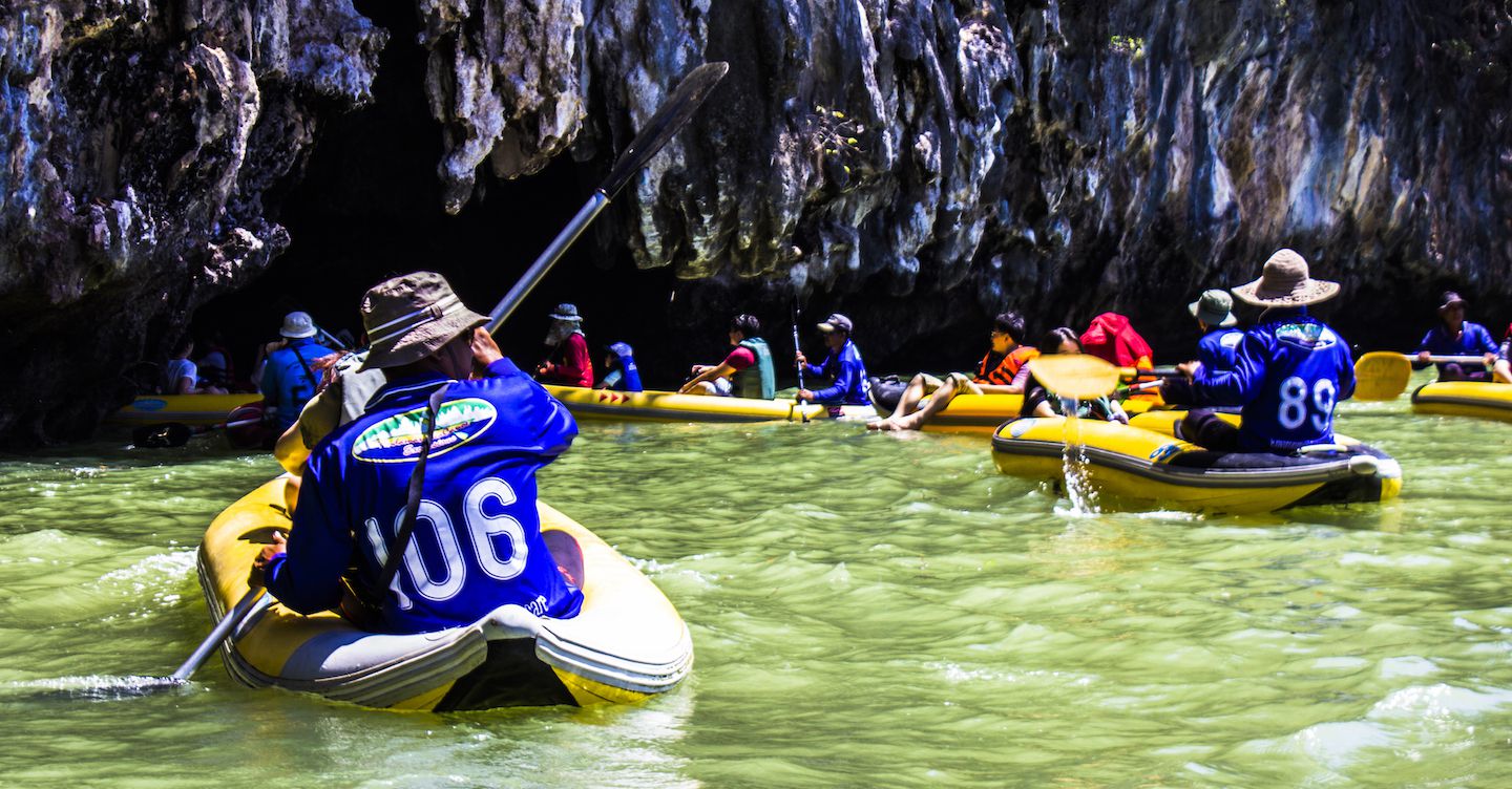 Canoeing into the small caves of Talu Island, Phang Nga Bay, Thailand